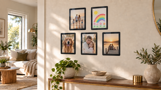 Gallery wall of photos hung without nails using Fodeez reusable adhesive frames on a textured apartment wall